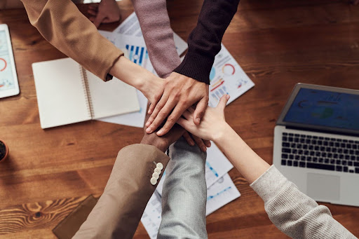 Several hands overlapping in a huddle